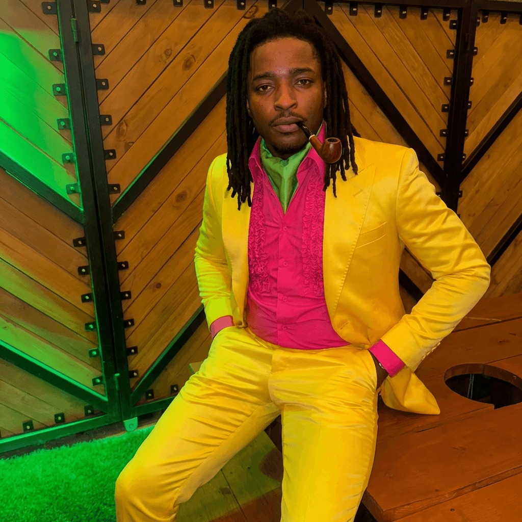 put man sitting down in yellow outfit matching lighting and stance of man in yellow outfit and location no glasses keep facial structure of man sitting down