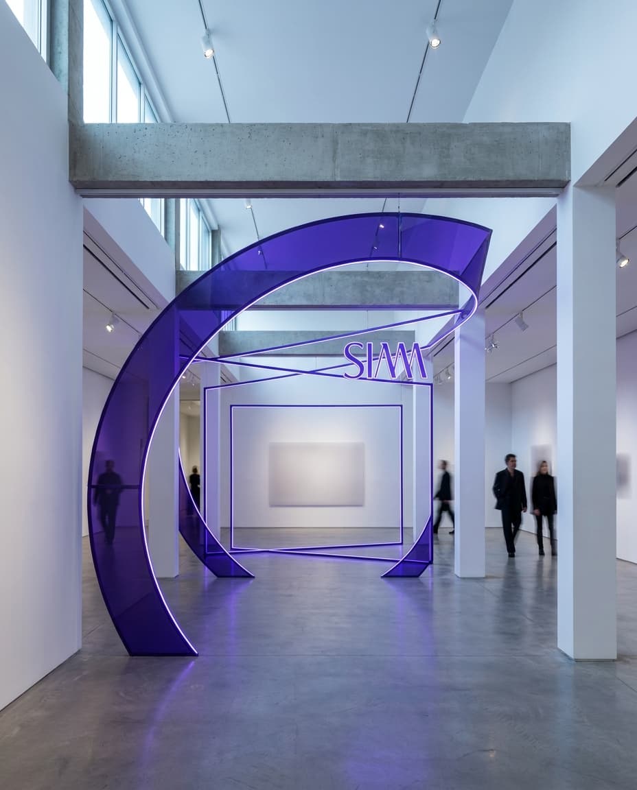 Final brand frame for Siam: bold composition leaving space for a CTA, accent color #7c3aed dominating the palette, sleek modern aesthetic, medium-pace energy, premium editorial finish, no readable text — preserve EXACT location identity: contemporary art gallery with white walls and exposed ceiling beams (indeterminate) — mixed soft and specular cool daylight light — white structural columns, polished concrete floors.