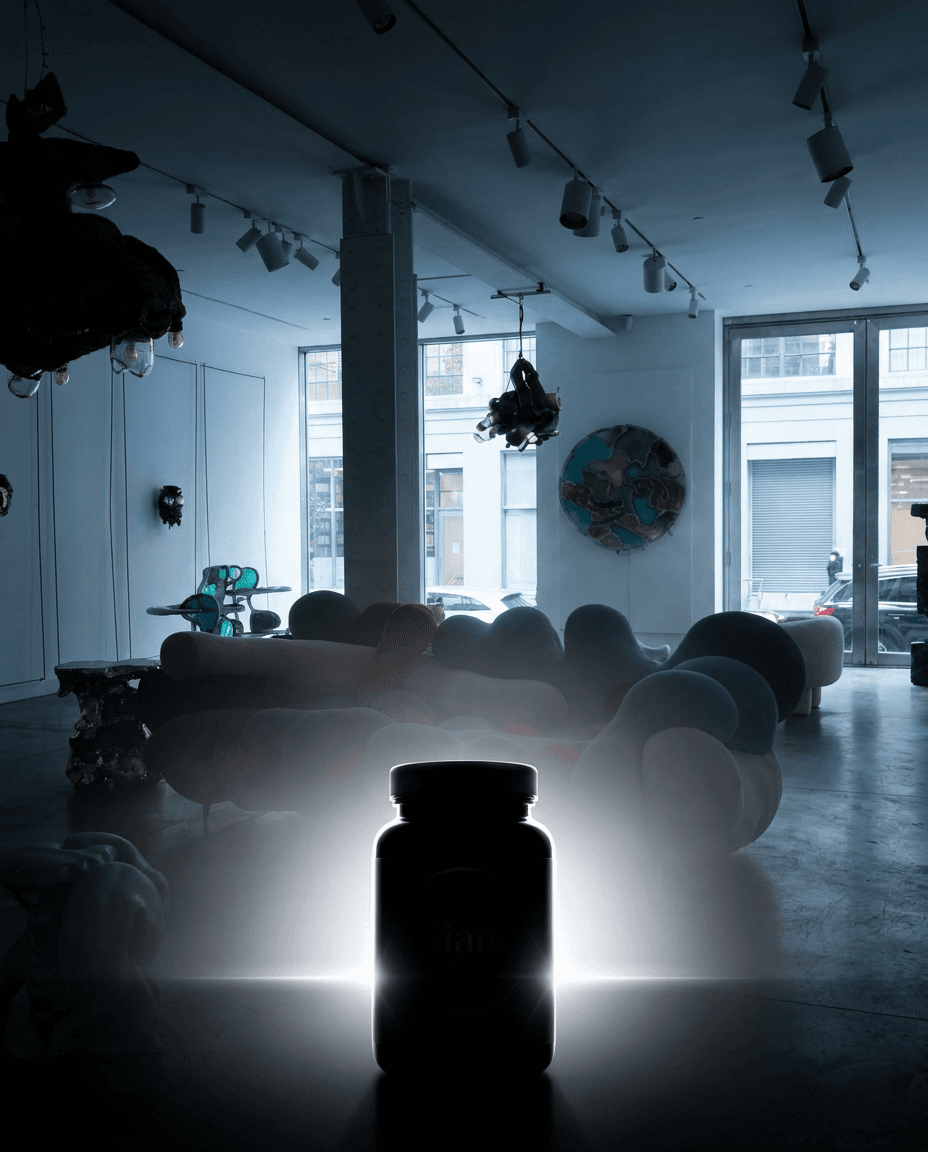 Mysterious teaser frame for Siam: dramatic medium-pace lighting in HYPE BEAST COMBO, deep shadows with a single rim-light hinting at a product silhouette, premium gradient background using accent color #ffffff, lens flare, atmospheric mist,  brand voice, ultra-detailed product-photography aesthetic, no readable text — preserve EXACT location identity: contemporary art gallery with white walls and concrete floors displaying sculptural furniture installations (indeterminate) — mixed soft and directional cool daylight light — white exposed ceiling with black track lighting system, large floor-to-ceiling windows facing urban street.

Keep the product as: product. Do not substitute the product with a different format (jar instead of bottle, tub instead of tin, plastic instead of glass, opened pack instead of sealed, etc.). Keep container kind, color, label, and visible text identical.