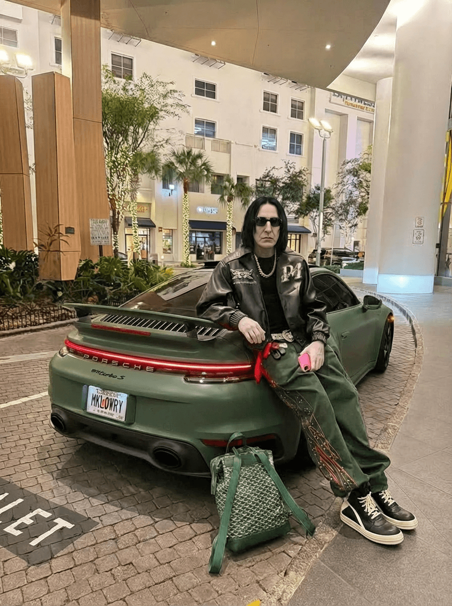 MAKE HIS HANDS THE SAME CAUCASION SKIN COLOR AS HIS FACE , CHANGE CAR COLOR TO MATTE GREEN , SNEAKERS ARE BLACK AN WHITE RICK OWENS