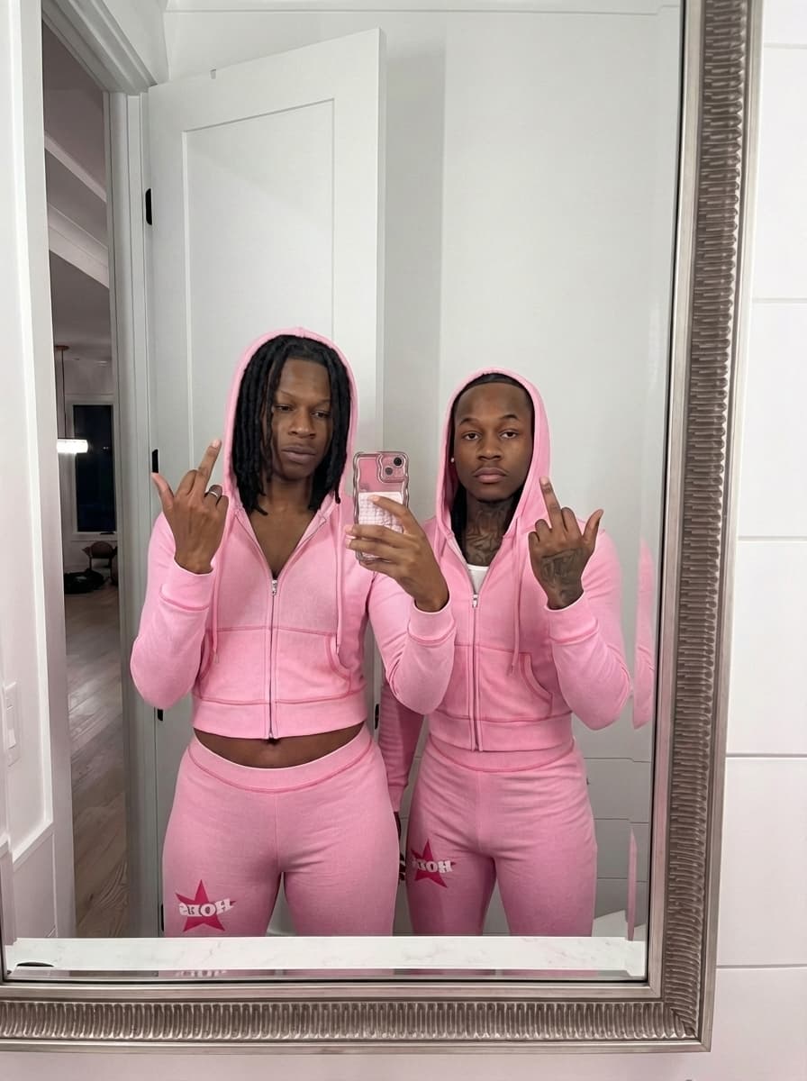 replace to man on left with the man in image 2 but keep him wearing pink 