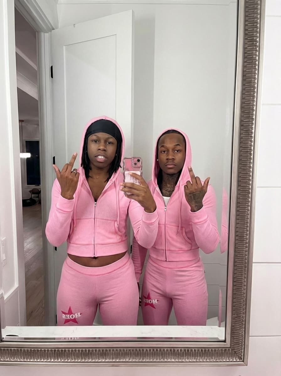 replace to man on left with the man in image 2 but keep him wearing pink 