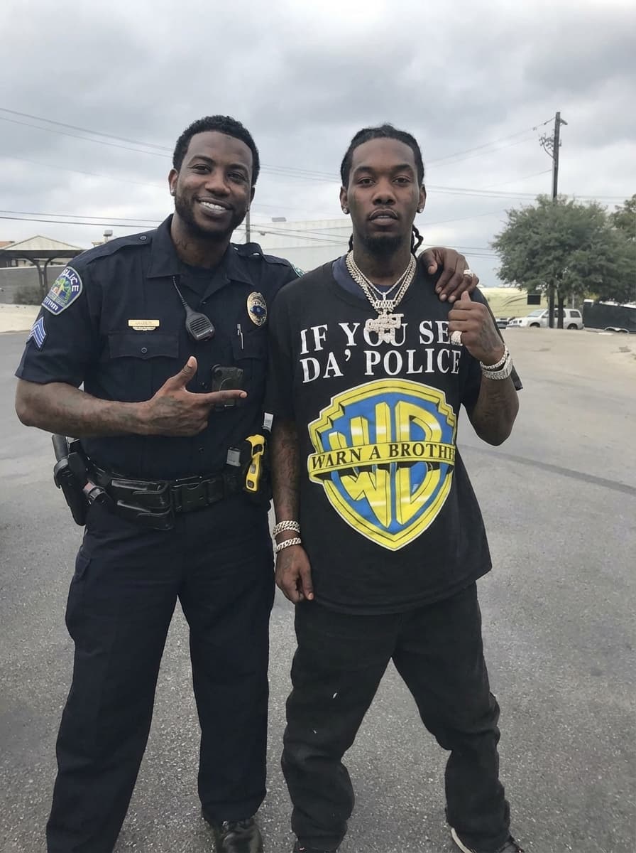 Use the provided image as the base reference. Maintain the exact same environment lighting, camera angle, pose, outfit structure, and composition from the original image. Replace the original subject with OFFSET THE RAPPER AN GUCCI MAN WITH A COP  wearing outfits attached