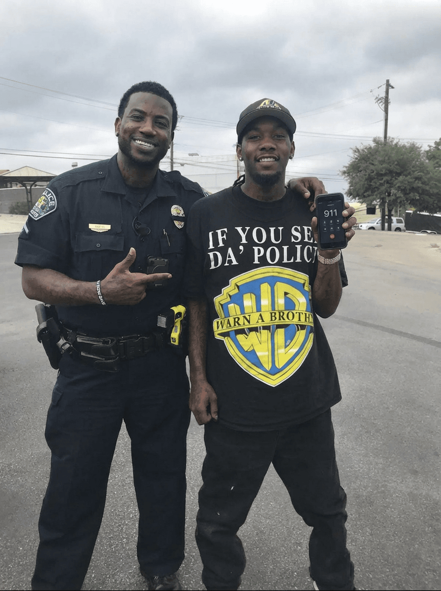Use the provided image as the base reference. Maintain the exact same environment lighting, camera angle, pose, outfit structure, and composition from the original image. Replace the original subject with OFFSET THE RAPPER AN GUCCI MAN WITH A BLACK FAT COP  wearing outfits attached HOLDING A PHONE WITH 911 ON IT