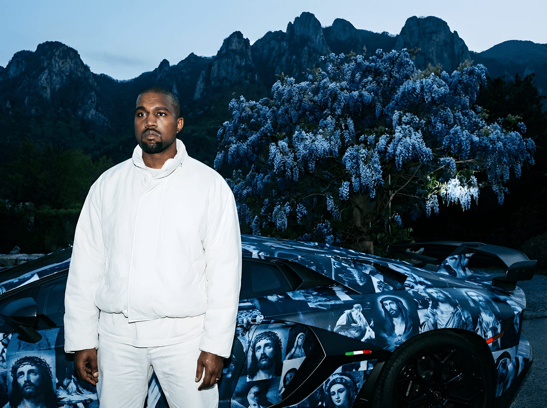 Kayne west and change the tree to a Blue Chinese Wisteria Tree, change the car to a Lamborghini  svj, add Jesus themed wrapped on the whole car the same color as the tree, kayne is wear all white ye style clothes Change the scene in to a mountain scene 

Camera Feel

• 35mm equivalent wide lens
• Slight perspective distortion (close, immersive)
• High dynamic range
• Crisp, ultra-sharp focus
• Raw candid energy
• Feels like spontaneous nightlife moment 

captured with hyper-detailed skin textures and luxury accessories.

Composition & Framing:
. aspect ratio, shallow depth of field focusing sharply on pores, wrinkles, and fabric
details.
Slight natural motion blur around edges for realism.

Lighting:
Harsh on-camera flash as primary light source, emphasizing skin texture — visible pores, fine
wrinkles, subtle imperfections, natural sheen of oil and sweat.
Rim lighting outlining faces, highlighting contours and hair strands.

details — slight gloss, tiny
creases.
Fine fabric texture of jacket sharply rendered, visible stitching and folds.
Subtle micro-blemishes and natural skin irregularities preserved for authenticity.

Color Grading & Mood:
Cool, desaturated color palette with warm highlights on skin tones.
Slight grain and natural digital noise to simulate high ISO, intimate paparazzi style.
Colors remain muted but rich, enhancing raw emotion and luxury contrast.

 
Post-processing:
No artificial smoothing or retouching; natural skin imperfections fully retained.
Minor chromatic aberration and lens artifacts for documentary authenticity.
Balanced highlights and shadows maintaining gritty, real-life feel.
Overall Impression:
An intensely intimate, raw moment frozen in time — decadent, luxurious, and unpolished. The
shot captures high-fashion opulence, with every pore,
wrinkle, and diamonds detail sharply in focus, telling a story of excess and proximity in the
underbelly of power and glamous