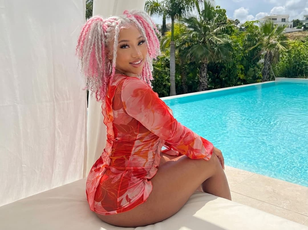 Replace the face, skin tone, and hairstyle of the black hair woman with the pink and white hair woman reference person, while keeping the original pose, body, outfit, lighting, and background unchanged. Ensure the result looks natural, realistic, and seamlessly blended