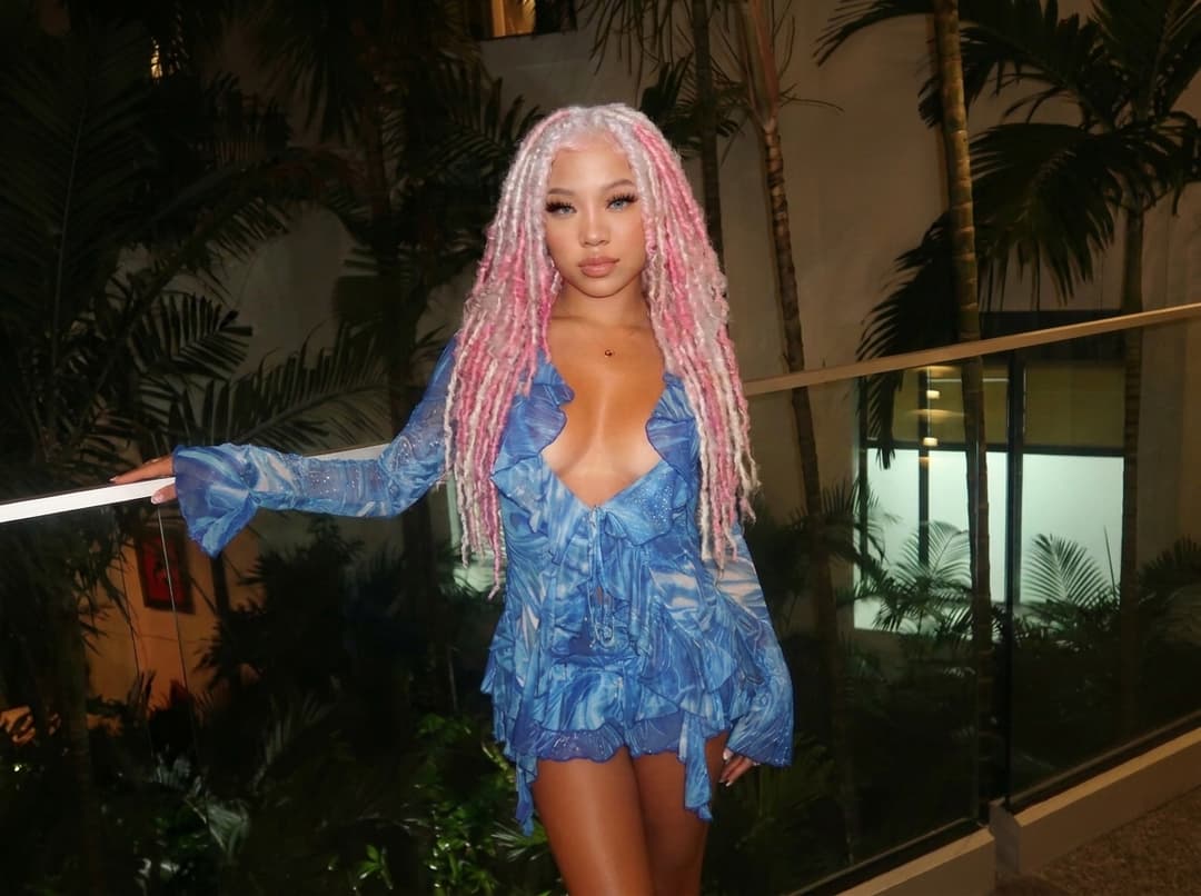 Let her hair down, keeping it in dreadlocks and maintaining the original color.
