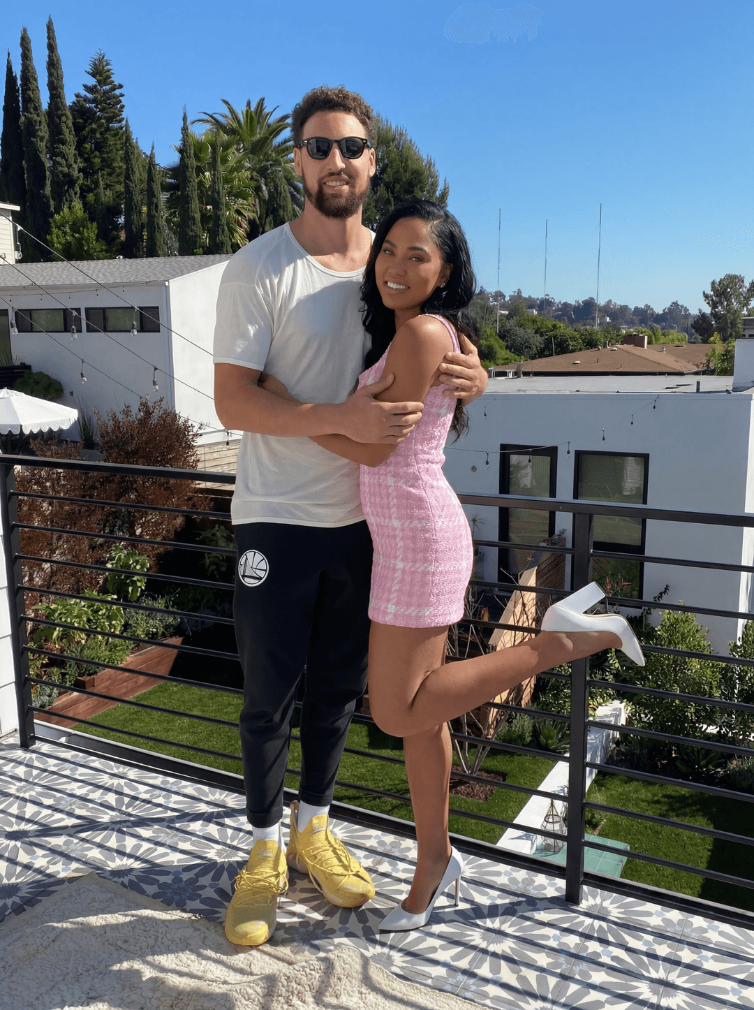 Completely remove and replace the woman in this photo with ayeshia curry make sure to remove all tatoos make it look ultra realstic and make sure all of his body matches the skin tone of who he is. keep her in the same outfits as the original. make the edit very clean and smooth as if there were no edits done at all. make sure that the end result is ayeshia curry as the woman 
