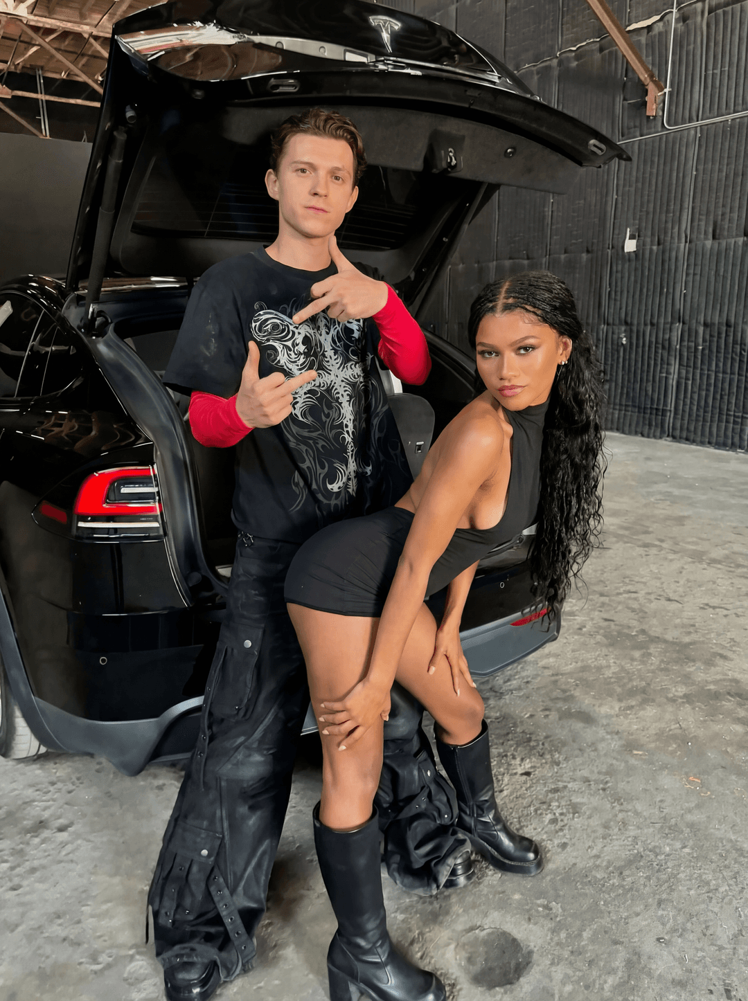Completely remove and replace the people in this photo with tom holland as the man and Zendaya from the show euphoria. make sure to remove all tatoos make it look ultra clean and make sure all of their body matches the skin tone of who they are. keep them in the same outfits as the original. make sure that the end result has zendeya as the woman

