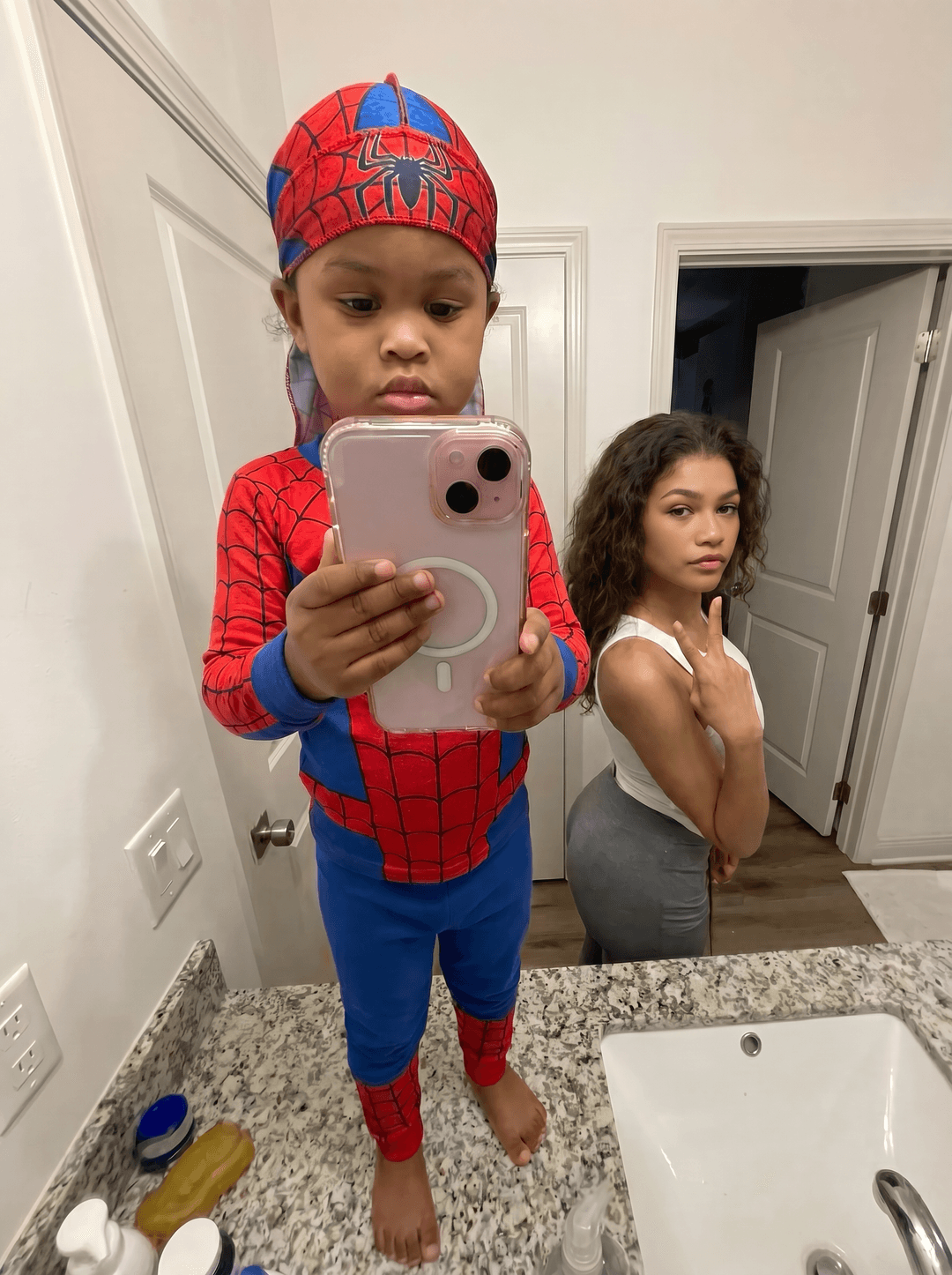 Completely remove and replace the woman in this photo with Zendaya from the show euphoria. make sure to remove all tatoos make it look ultra clean and make sure all of her body matches the skin tone of who she are. keep them in the same outfits as the original. make sure that the end result has zendeya as the woman
