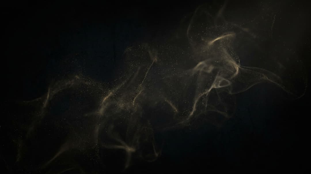 black with faint amospheric gold partical dust smoke wallpaper 4k cinematic