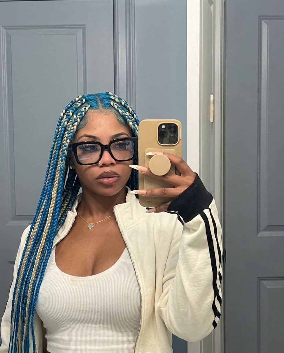 Swap female out with reference female. Keep same outfit from image 1. Change hairstyle to box braids but keep same hair color.