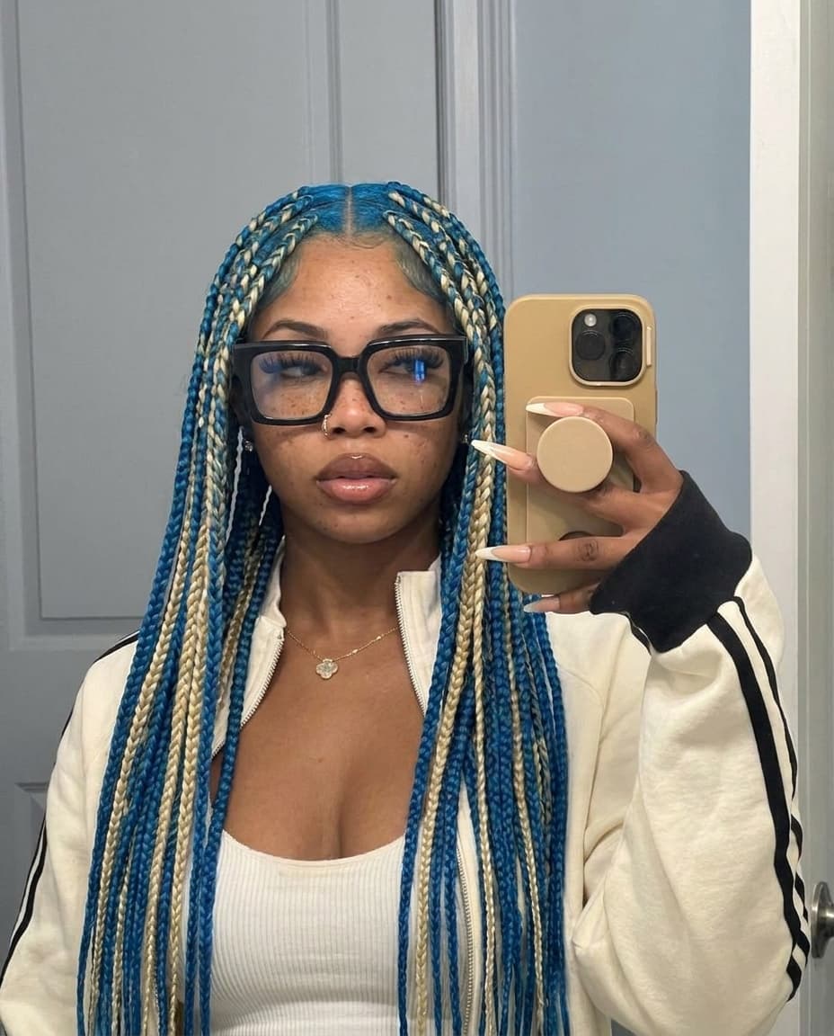 Swap female out with reference female. Keep same outfit from image 1. Change hairstyle to box braids but keep same hair color.