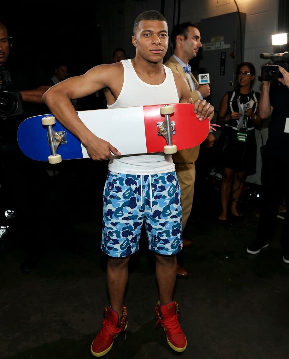 Keep everything the same. Swap character with mbappe white tank top, blue camo bape shorts. 4k resolution, realistic skin texture. Skateboard is france flag design.