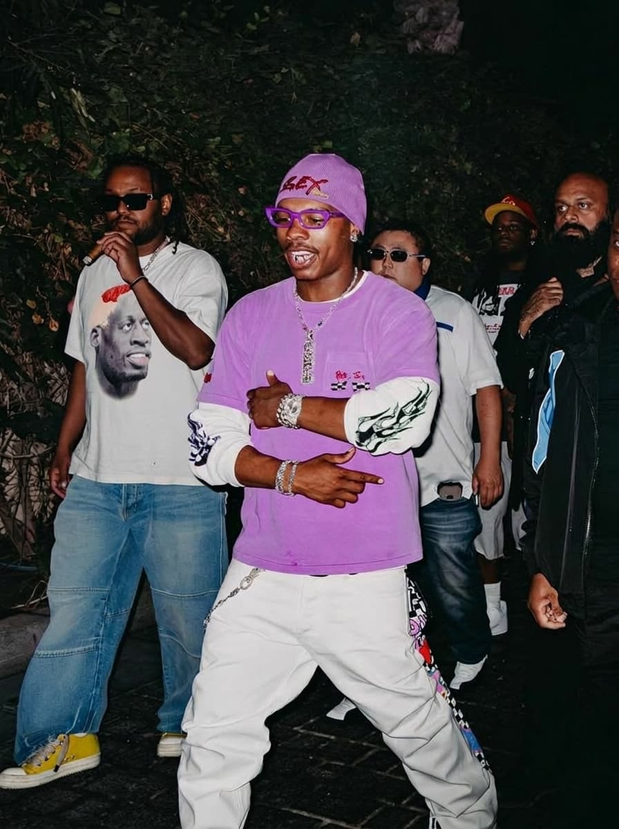Use the provided image as the base reference. Maintain the exact same environment lighting, camera angle, pose, outfit structure, and composition from the original image.
Replace the original subject with The Notorious B.I.G.,Music Icon wearing outfits attached
