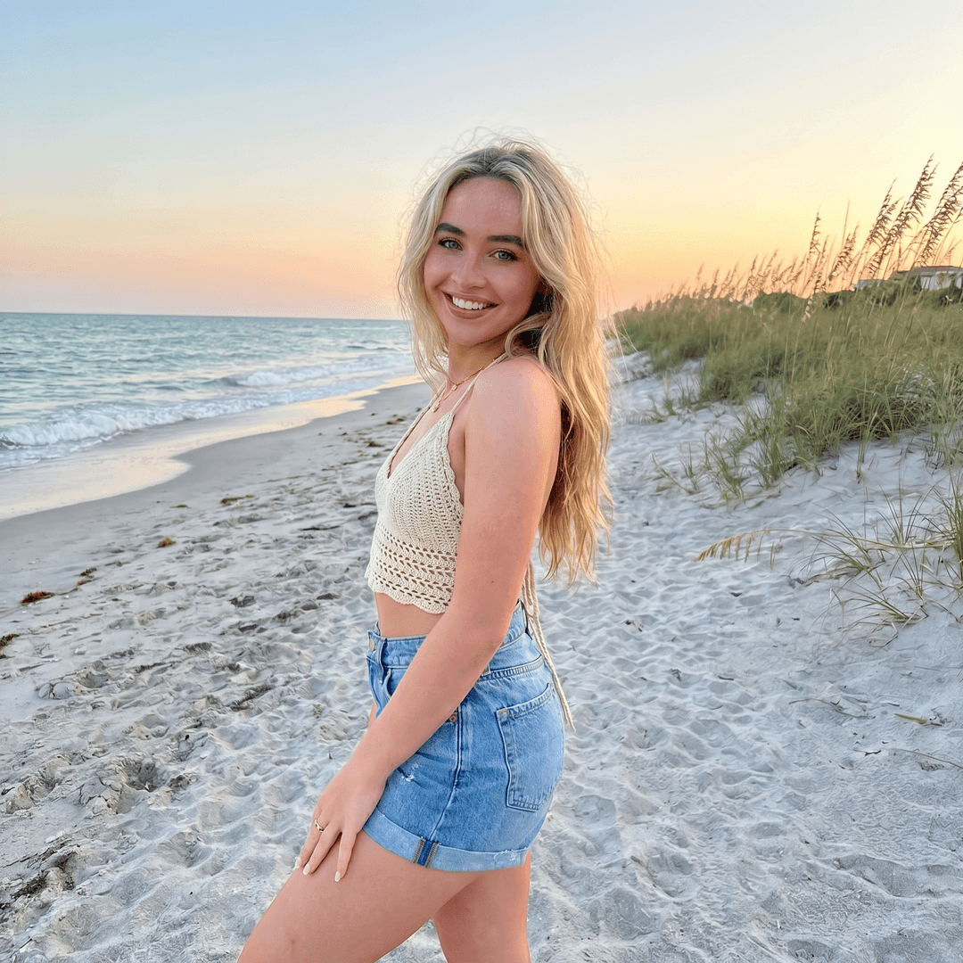 Sabrina Carpenter posing on the beach