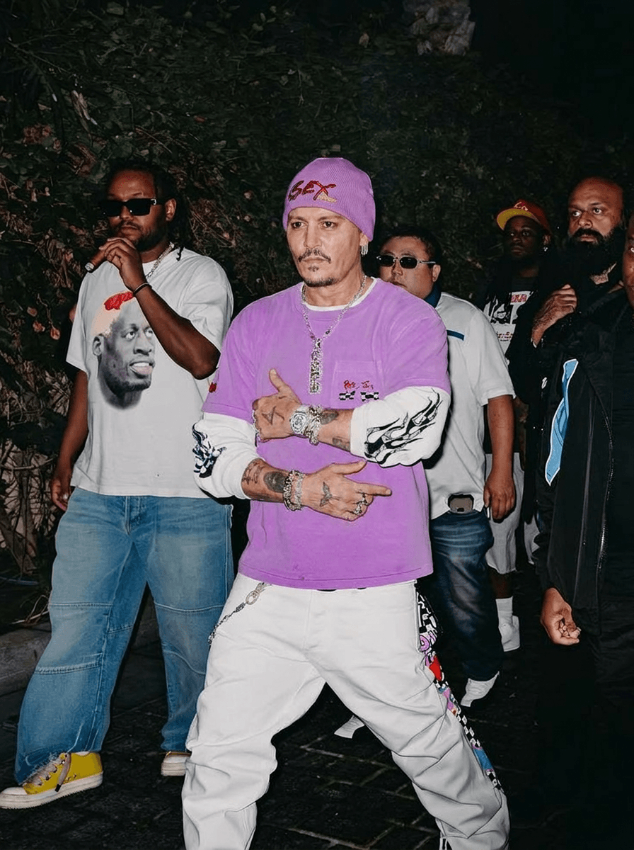 Use the provided image as the base reference. Maintain the exact same environment lighting, camera angle, pose, outfit structure, and composition from the original image.
Replace the original subject with Johnny Depp,Movie Actor wearing outfits attached
