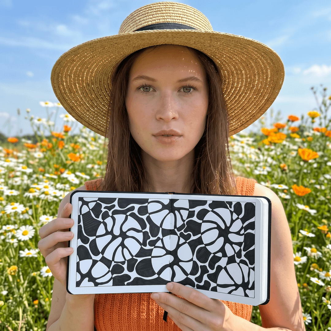 A close-up, medium shot captures the woman in the uploaded reference image (DO NOT TOUCH FACE) from the chest up, standing in a field of daisies and orange wildflowers under a clear blue sky. They are also wearing a cropped, sleeveless orange tank top made of a textured, slightly wrinkled cotton fabric. Their head is slightly tilted, and they gaze directly at the camera with a neutral expression. Blond hair with loose waves falls around their shoulders. Several daisies and orange flowers are in sharp focus in the foreground, creating a natural frame around the subject. The background consists of more flowers and the bright sky. Sunlight passes through the straw weave. Shot with a 24–28mm wide-angle lens for dramatic perspective. Natural framing from flowers and straw hat around the face. Bright natural midday sunlight. Subtle shadows under the hat brim. Photorealistic. HDR. some flowers blurred in the foreground for natural framing.