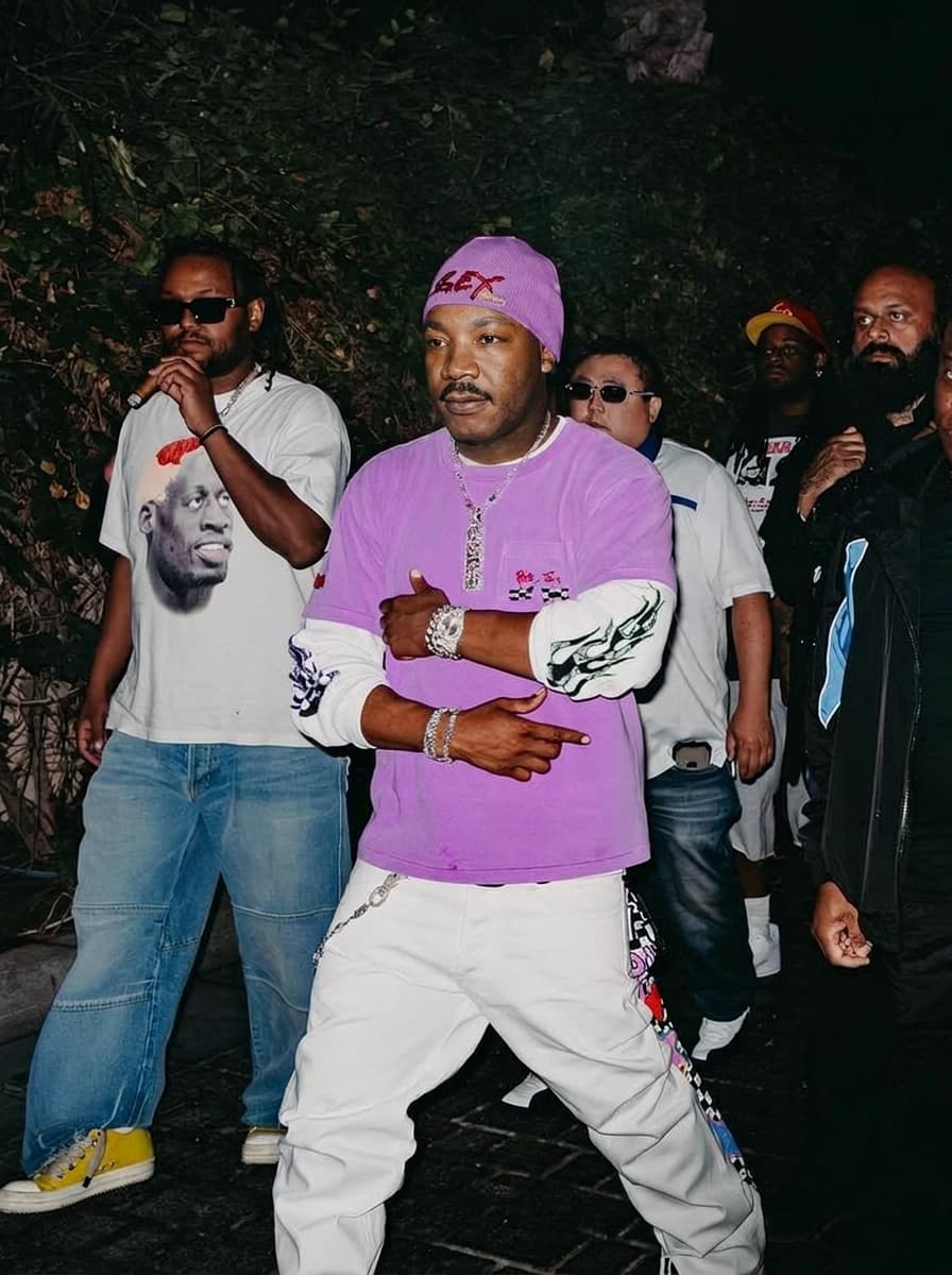 Use the provided image as the base reference. Maintain the exact same environment lighting, camera angle, pose, outfit structure, and composition from the original image.
Replace the original subject with Martin Luther King Jr.,Political Leader wearing outfits attached