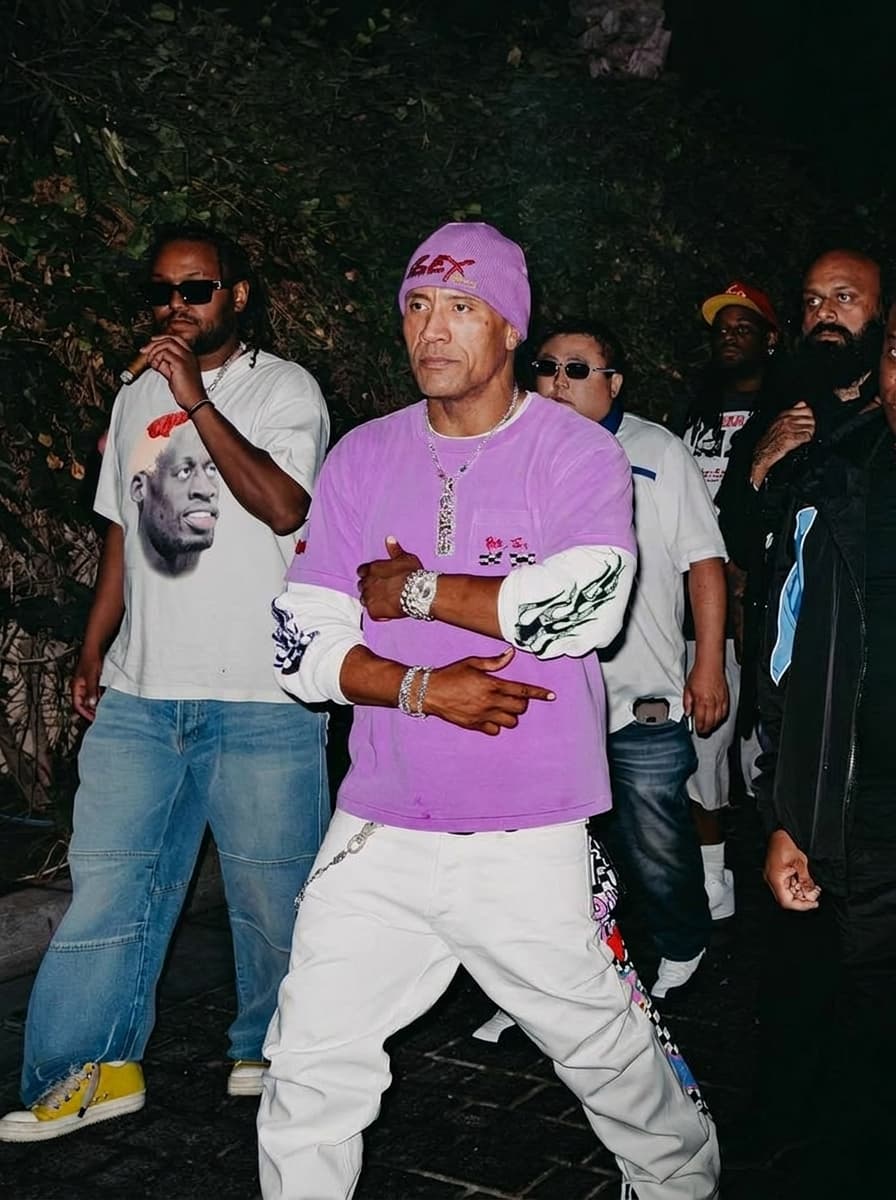 Use the provided image as the base reference. Maintain the exact same environment lighting, camera angle, pose, outfit structure, and composition from the original image.
Replace the original subject with Dwayne Johnson,Movie Actor wearing outfits attached
