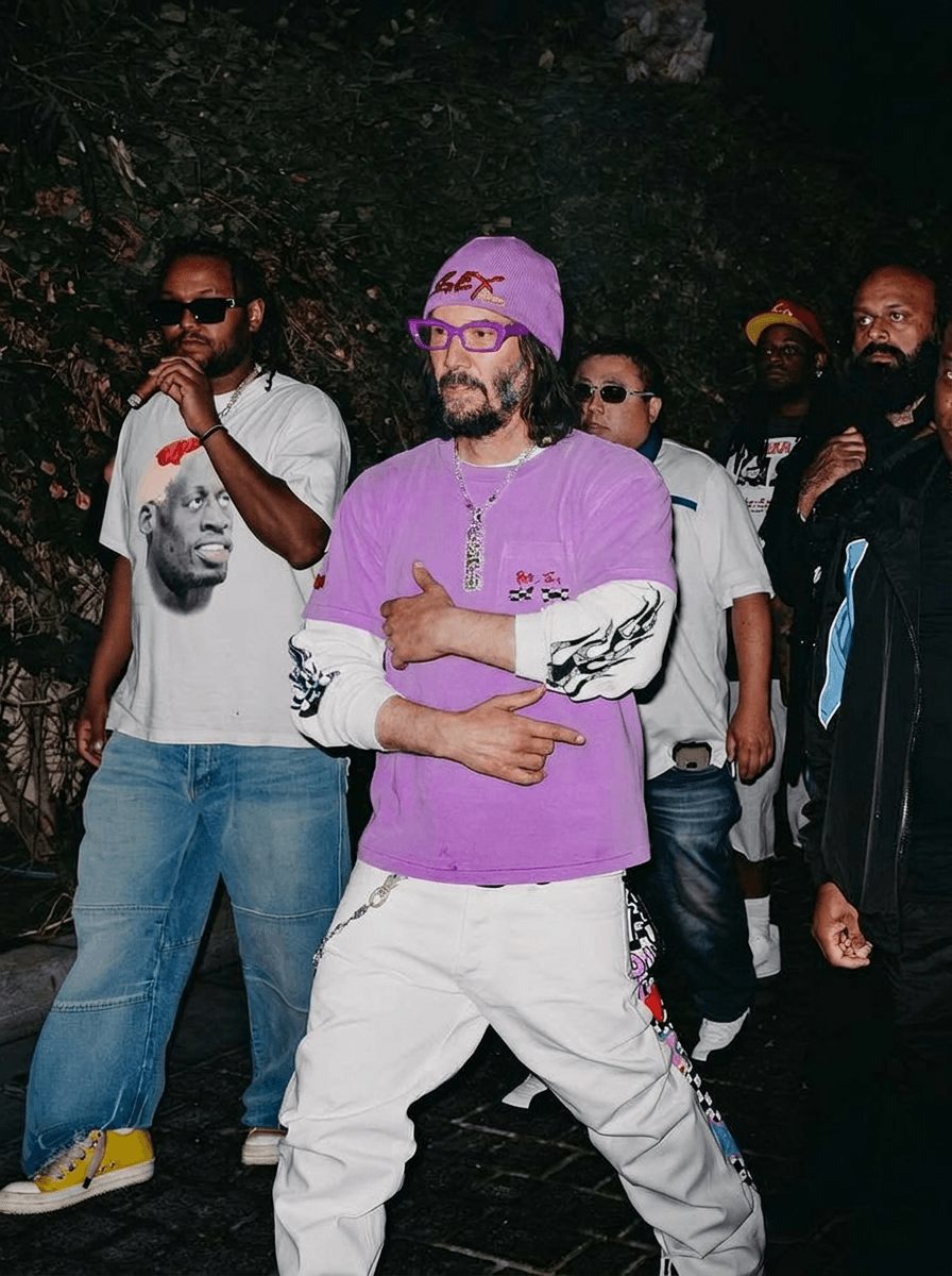 Use the provided image as the base reference. Maintain the exact same environment lighting, camera angle, pose, outfit structure, and composition from the original image.
Replace the original subject with Keanu Reeves,Movie Actor wearing outfits attached