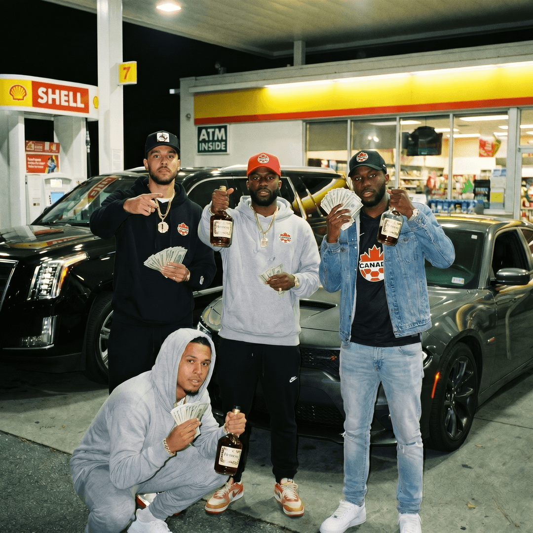 Put alphonso davies, Johnathan david, stephen eustaquio, and alistair johnston) from the canada mens national team dressed like atlanta thugs in a gas station flexing cash, cars, and bottles of hennesy